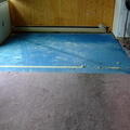 Carpet removal begins, showing the pad.