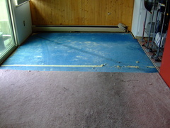 Carpet removal begins, showing the pad.
